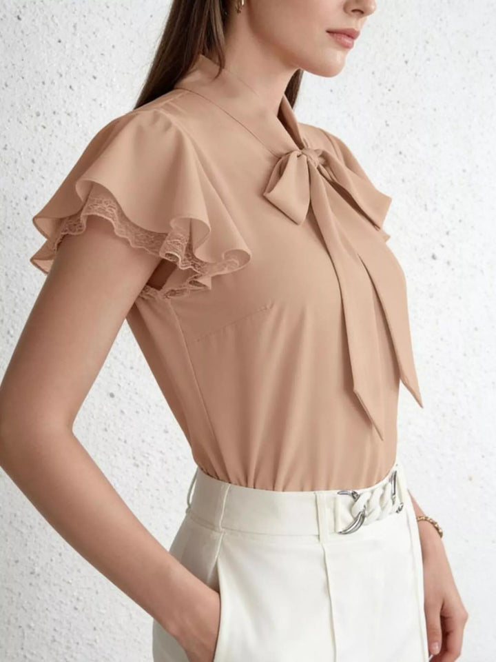 Tie-neck ruffle cap sleeve blouse with lace trim