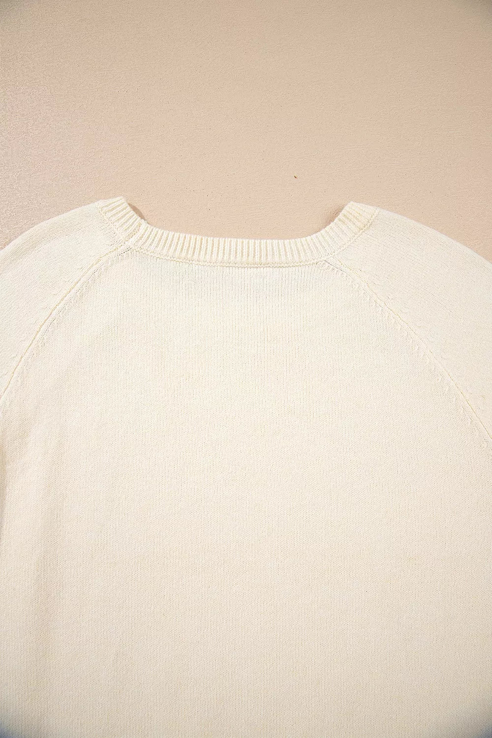 Button-cuff raglan sleeve crew neck sweater