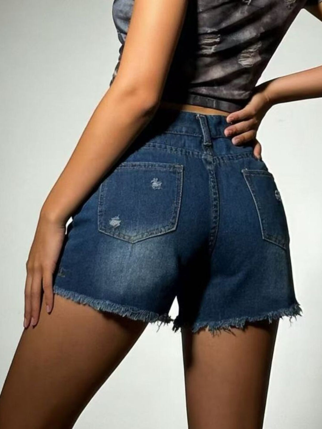 Distressed high-rise denim shorts with frayed raw hem
