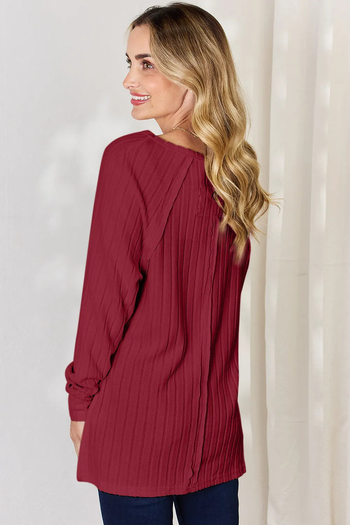 Ribbed knit round neck long sleeve top with side slits