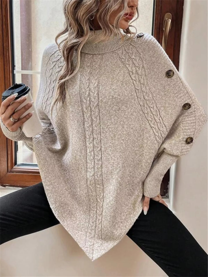 Cable knit turtleneck cape sweater with button shoulder