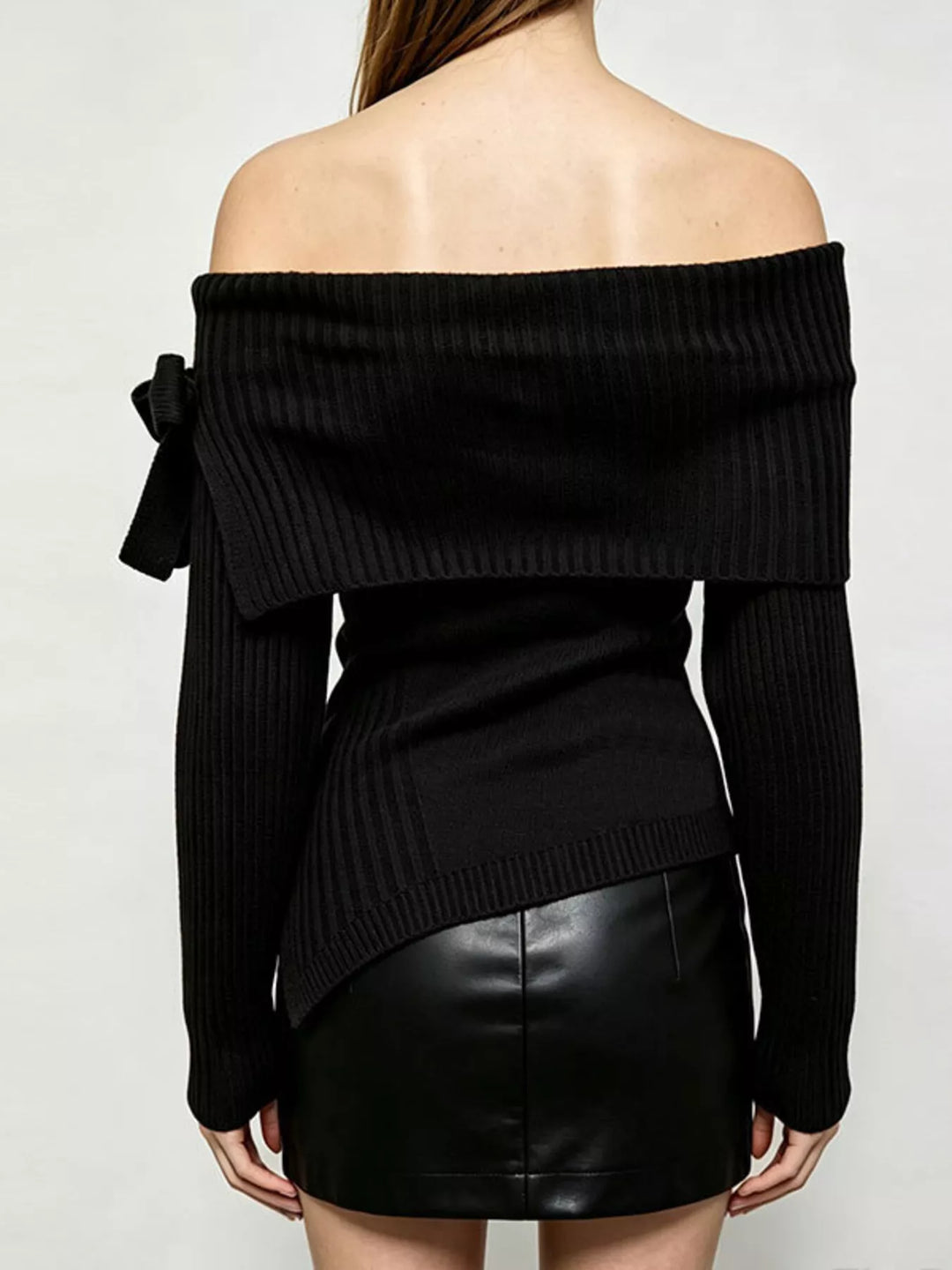 Off-shoulder ribbed knit top with bow cuff and asymmetric hem