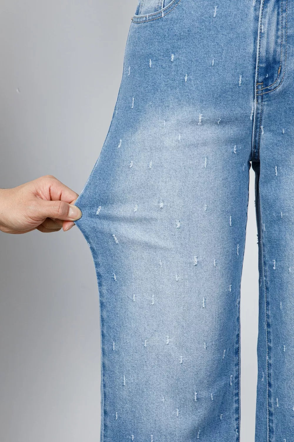 Distressed wide-leg jeans with tummy control and raw hem