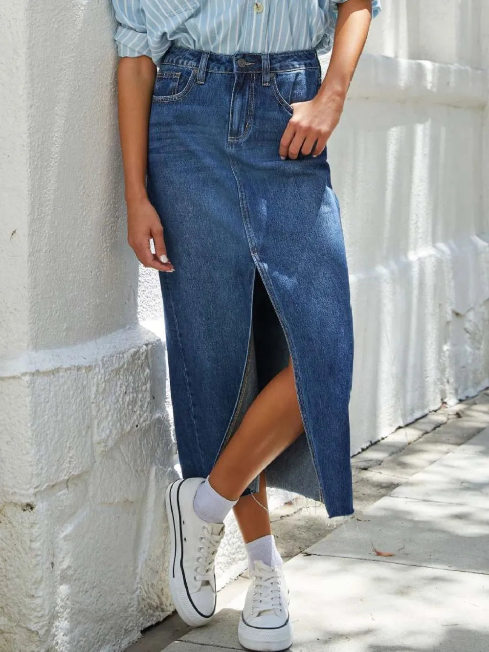 High-rise denim midi skirt with raw hem and front slit