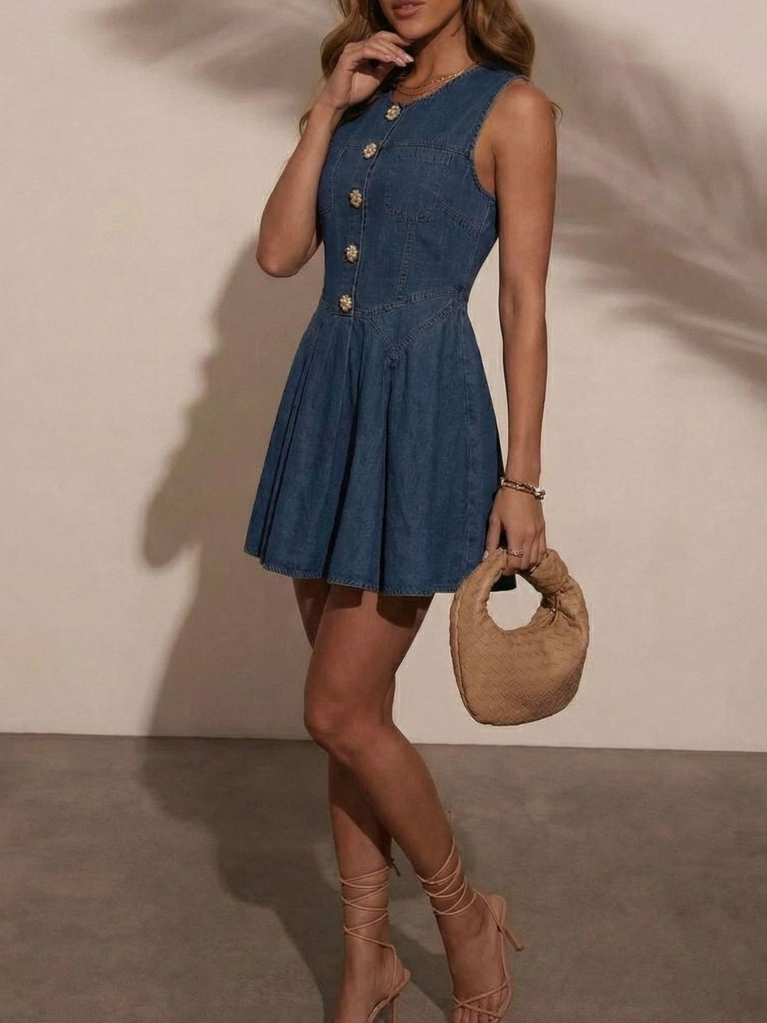 Sleeveless denim mini dress with jeweled buttons