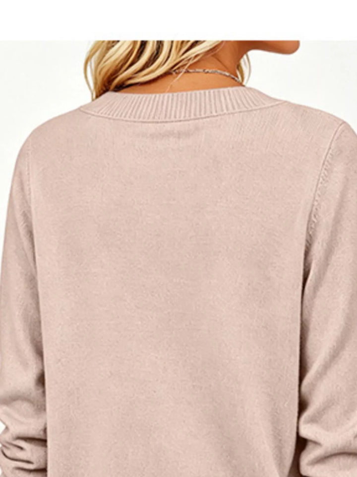 V-neck long sleeve sweater with button cuffs and side slits
